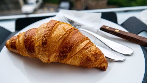 Close-up of croissant in plate on table