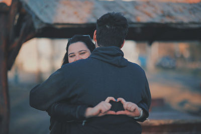 Rear view of couple standing outdoors