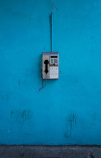 Telephone on blue wall