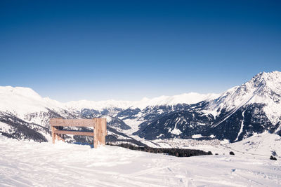 Scenic view of snowcapped mountains against clear blue sky