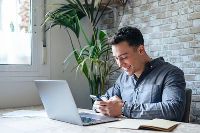 Young man using laptop at office
