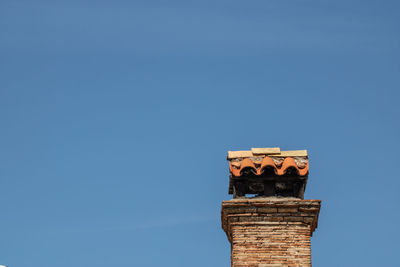 Low angle view of building against clear blue sky