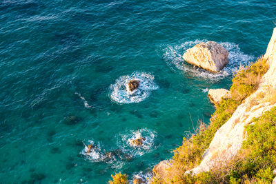 High angle view of rock formation in sea