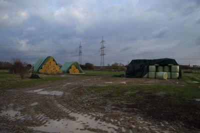 Tent on field against cloudy sky