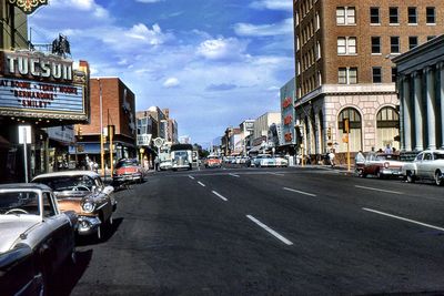 Vehicles on road along buildings