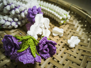 Close-up of purple flowers in basket on table