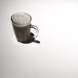 High angle view of coffee cup on white background