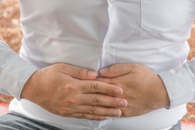 Midsection of couple holding hands