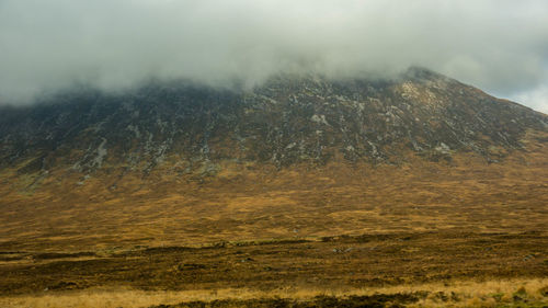 Scenic view of landscape against cloudy sky