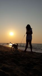 People on beach at sunset