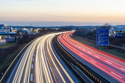 High angle view of light trails on road at sunset