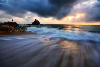 Scenic view of sea against cloudy sky