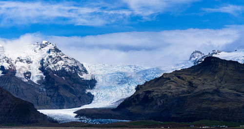 Scenic view of snowcapped mountains against sky