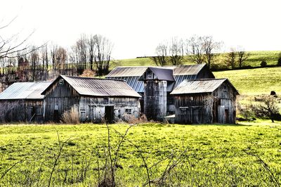 Barn on field against sky