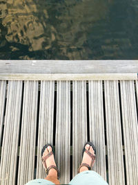 Low section of man standing on pier