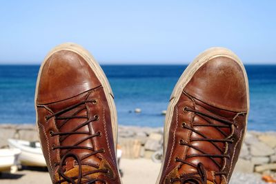 Low section of man wearing brown shoes