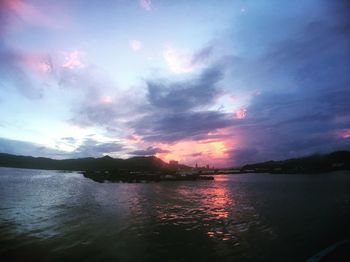 Scenic view of lake against sky at sunset