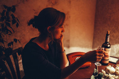 Full length of a young woman drinking glass