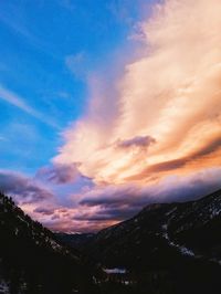 Scenic view of mountains against cloudy sky