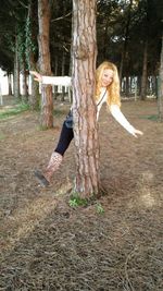 Man standing on tree trunk in park