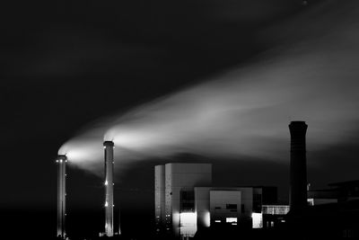 Factory against sky at night