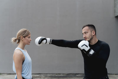 Full length of young man standing against wall
