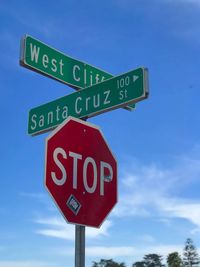 Low angle view of road sign against sky