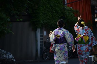 Rear view of women in kimonos