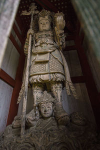 Low angle view of statue against building