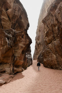 The desert walker. man walking through a canyon in the desert of wadi rum. 