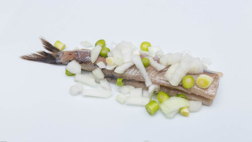 High angle view of chopped vegetables on white background