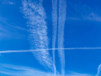 Low angle view of vapor trail against blue sky