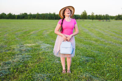 Full length of woman standing on field
