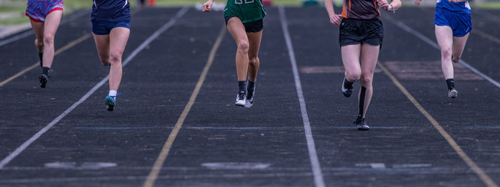 Full frame view of runners sprinting towards the finish line