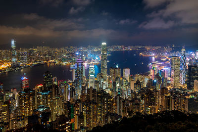 Illuminated cityscape against sky at night