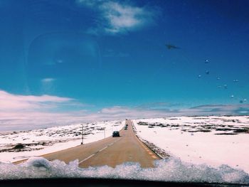 Scenic view of landscape against blue sky