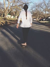 Woman walking on road