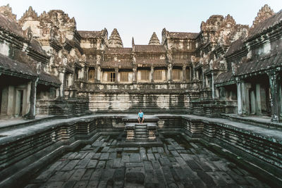 Man sitting at abandoned temple