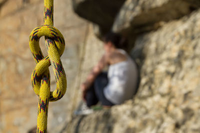 Close-up of rope hanging on rock