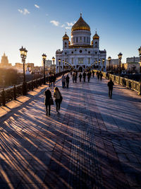 People walking on patriarshy bridge leading towards temple of christ the savior