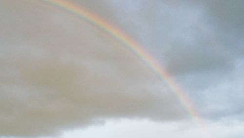 Low angle view of rainbow against sky