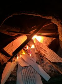 Low angle view of illuminated lamp at night