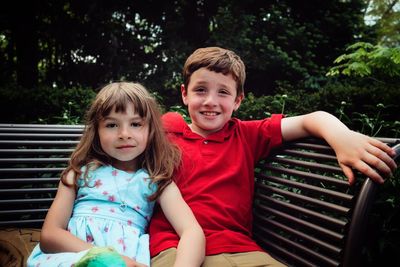 Portrait of a smiling girl sitting outdoors