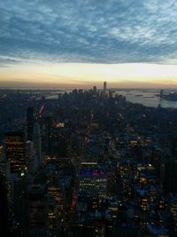 Aerial view of city lit up at sunset