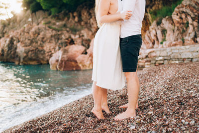 Low section of woman standing on rock