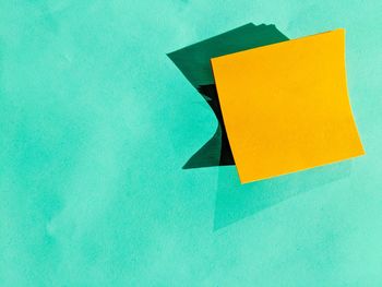 Close-up of yellow paper on wall