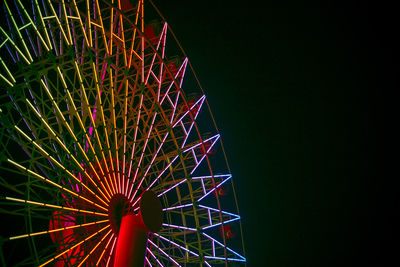 Low angle view of ferris wheel against sky at night