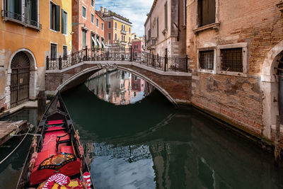 Arch bridge over canal against buildings