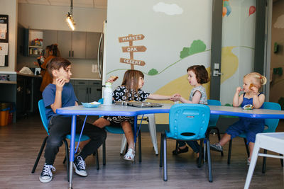 Children sit for lunchtime at an educational facility