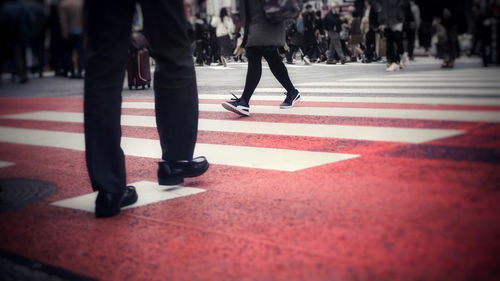 Low section of people walking on road